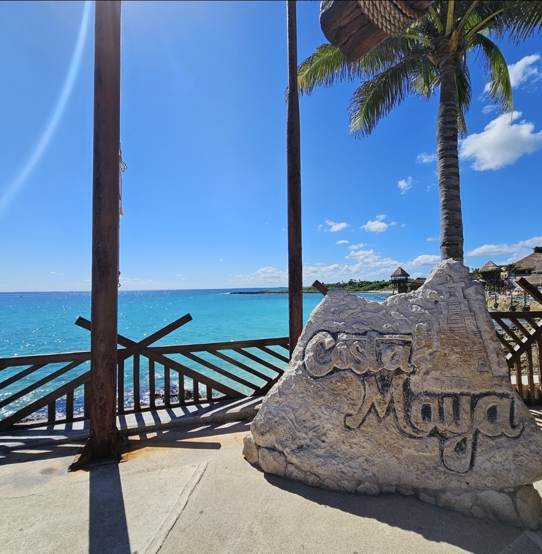 Turquoise Caribbean water framed by palms at Costa Maya