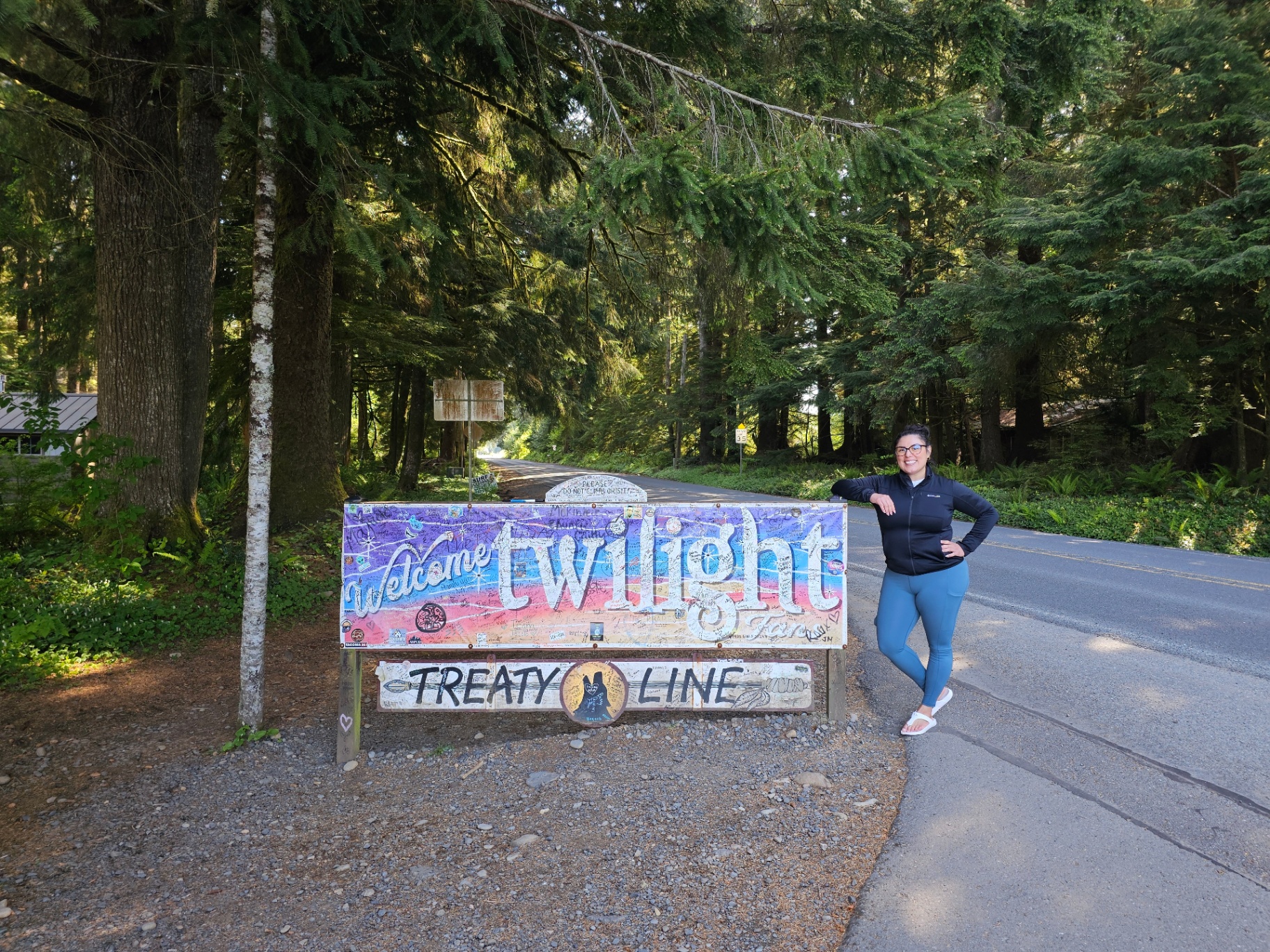Woman beside the Welcome to Twilight treaty line sign