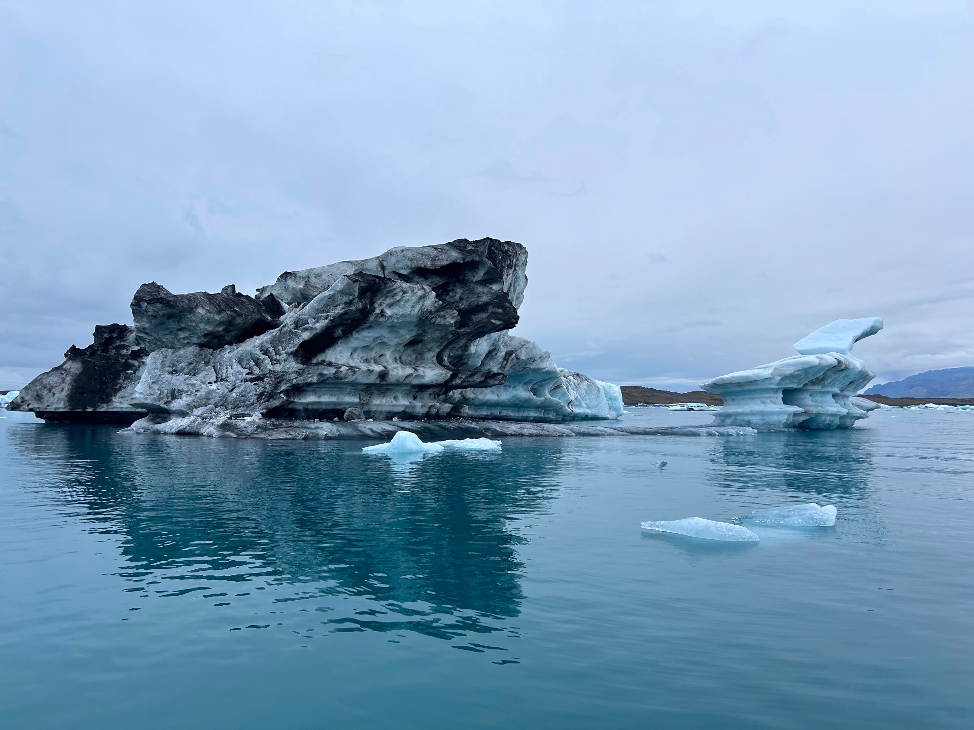 Icebergs drifting on the still water of Jökulsárlón glacier lagoon