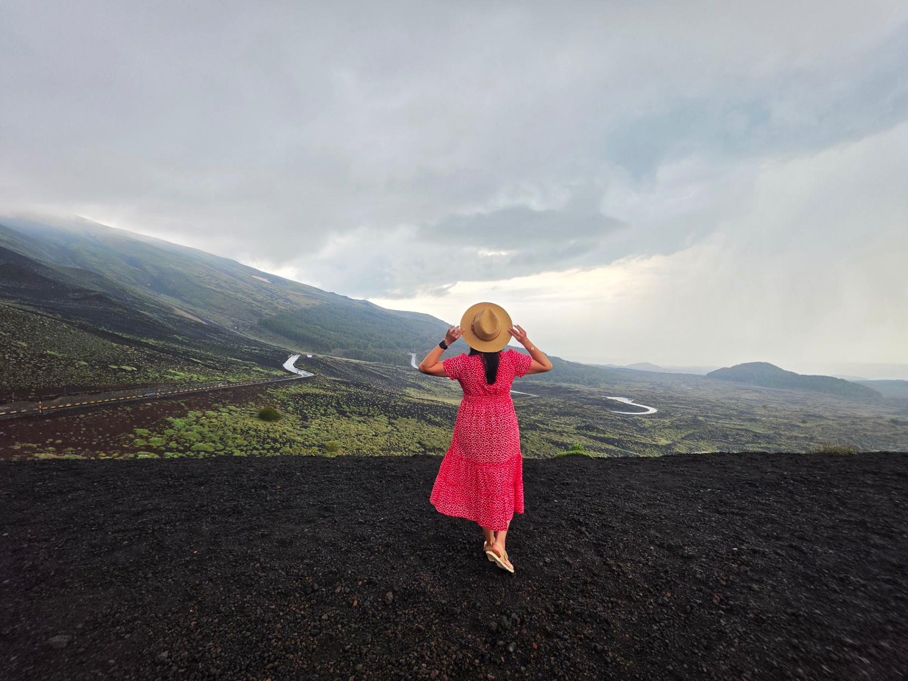 Woman in a red dress on the slopes of Etna