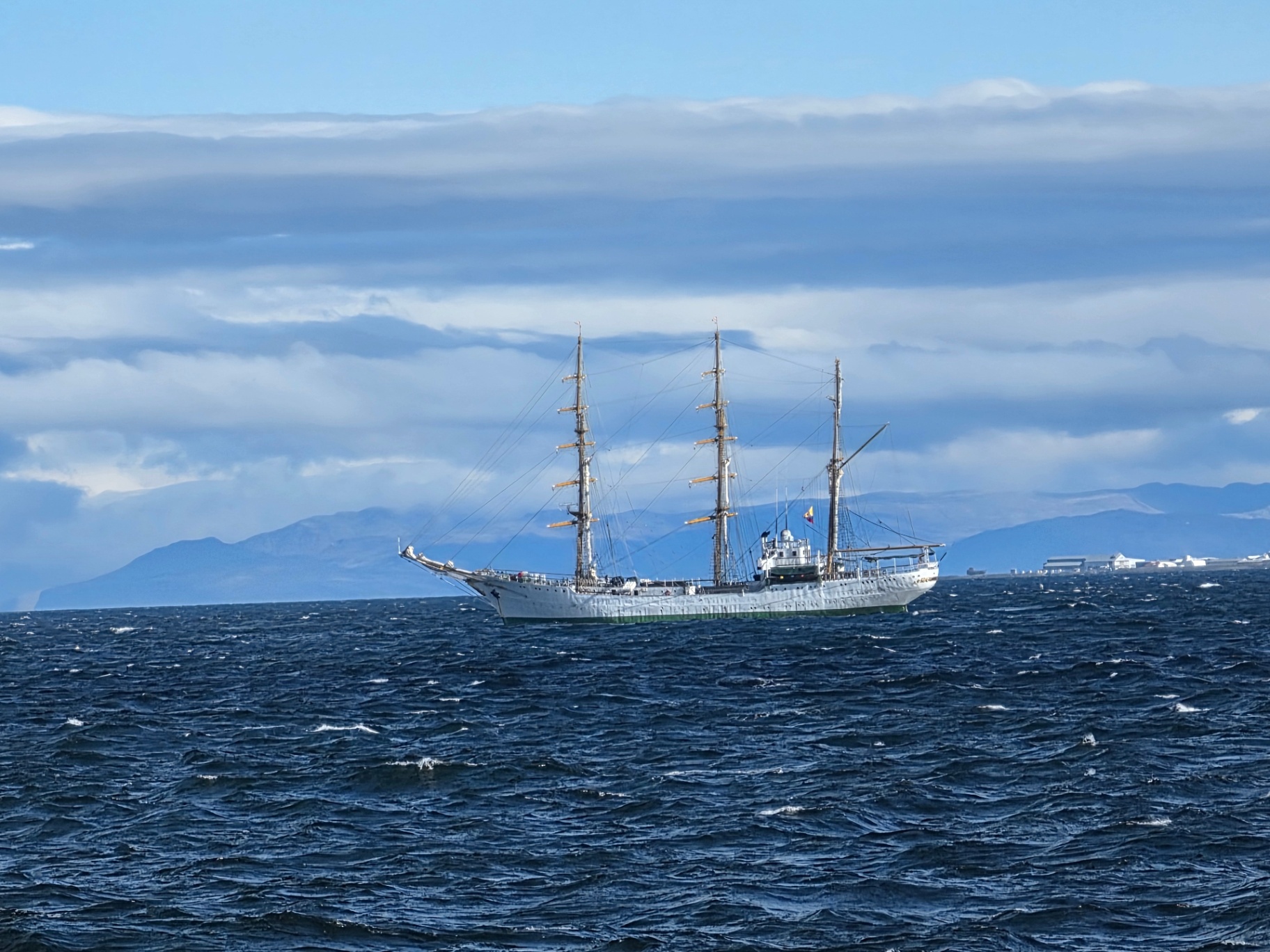 A three-masted tall ship anchored off the Icelandic coast